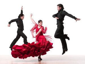 Two men and one woman dancing flamenco